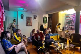 Ukraine fans watch the national team's group match against Slovakia in the 2024 Euros at Stunner vintage football shirt shop in Manchester. 