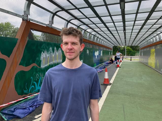 Alex Teague, 20, volunteered to paint the Thomson Street Bridge in Stockport. 
