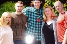 George Atkinson (centre) with his family including mum Tracy (second right)