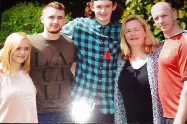 George Atkinson (centre) with his family including mum Tracy (second right)