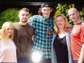 George Atkinson (centre) with his family including mum Tracy (second right)