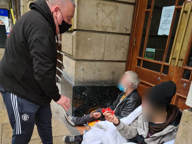 Two Brews founder Dave Evans talking to rough sleepers in Manchester