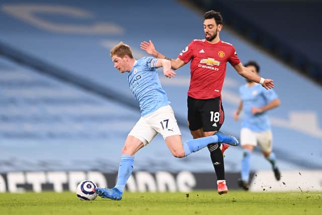 Kevin De Bruyne and Bruno Fernandes battle for the ball. Credit: Getty.