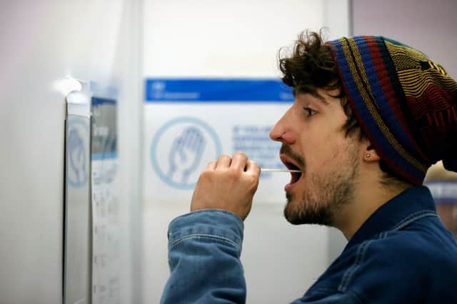 A man carrying out a test  at a NHS Test and Trace Covid-19 testing unit  Credit: AFP/Getty Images