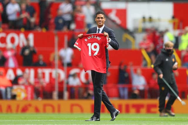 New signing, Raphael Varane of Manchester United is introduced to fans on the pitch prior to the Premier League match between Manchester United  and  Leeds United at Old Trafford on August 14, 2021  (Photo by Catherine Ivill/Getty Images,)