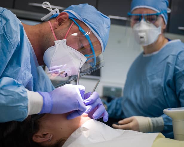 A dentist and a dental nurse carry out a procedure on a patient. Photo: Leon Neal/Getty Images