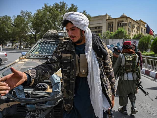Taliban fighters stand guard along a street at the Massoud Square in Kabul on August 16, 2021. (Photo by Wakil Kohsar / AFP) (Photo by WAKIL KOHSAR/AFP via Getty Images)