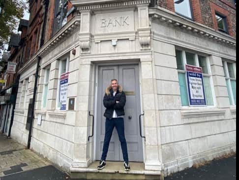Adam Deering outside the bank he bought which once refused him a business loan