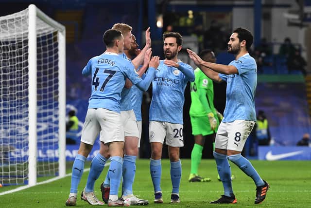 Manchester City players celebrate scoring a goal. Credit: Getty.