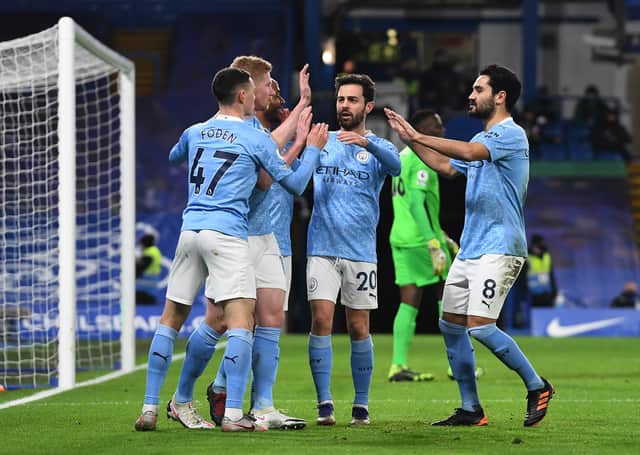 <p>Manchester City players celebrate scoring a goal. Credit: Getty.</p>