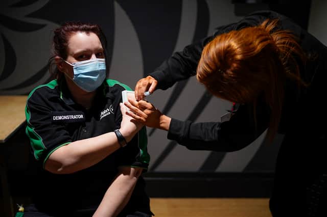Volunteers were trained by St John Ambulance instructors to administer Covid-19 vaccines at Old Trafford earlier this year  Credit: Getty Images