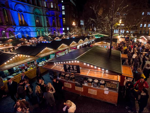 <p>Shoppers enjoy Manchester’s Christmas Market with food stalls, bars, Christmas decorations and various gift stalls outside Manchester Town Hall.  Photo: Richard Stonehouse/Getty Images</p>