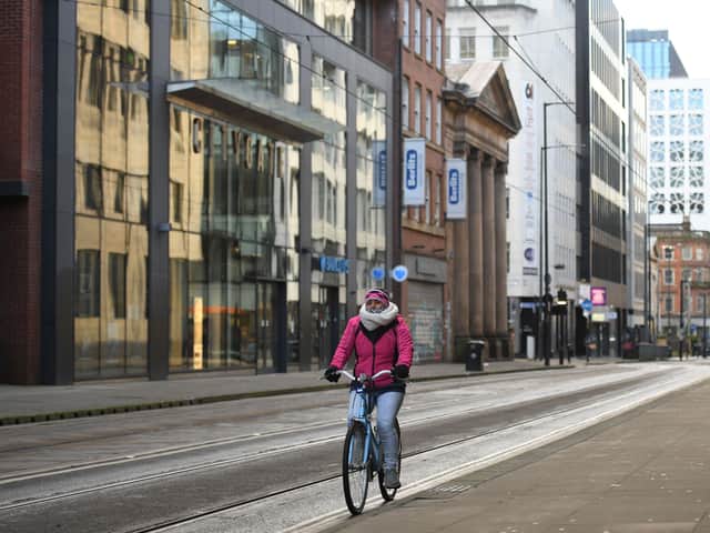 A cyclist riding through Manchester. Photo: Oli Scarff/AFP via Getty Images