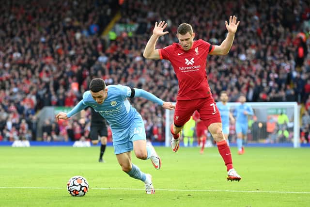 LIVERPOOL, ENGLAND - OCTOBER 03: Phil Foden of Manchester City breaks past James Milner of Liverpool during the Premier League match between Liverpool and Manchester City at Anfield on October 03, 2021 in Liverpool, England. (Photo by Michael Regan/Getty Images)