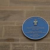 A blue plaque on the side of the University wall in Manchester commemorating Ellen Wilkinson, Labour politician and first female Minister of Education.