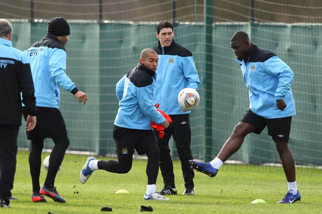 Micah Richards of Manchester City is challenged for the ball by Nigel De Jong during a training session in 2012. Credit: Getty.