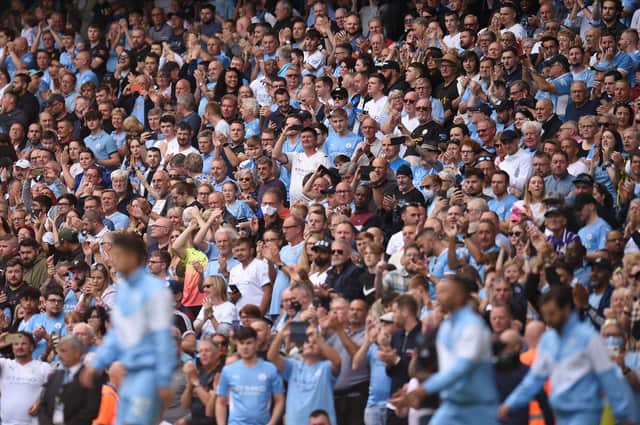 Manchester City fans greet their team ahead of the English Premier League football match between Manchester City and Southampton at the Etihad Stadium in Manchester, north west England, on September 18, 2021. (Photo by OLI SCARFF/AFP via Getty Images)
