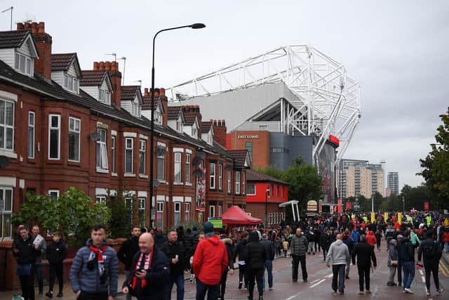 Fans arrive outside the stadium prior to the Premier League match between Manchester United and Everton at Old Trafford on October 02, 2021 in Manchester, England. (Photo by Michael Regan/Getty Images)