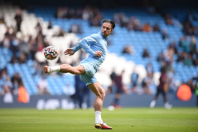 <p>Jack Grealish warms up for Manchester City. Credit: Getty.</p>