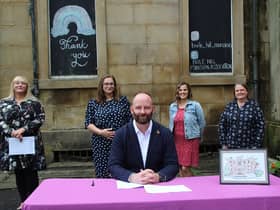 Salford mayor Paul Dennett signs an agreement with Buile Hill Mansion Association (L-R: Jennifer-Anne Smith, Petra Vanila Vartovnikova, Markéta Crehan Lážová and Wendy Francis). Credit: Salford City Council. Caption: Joseph Timan.