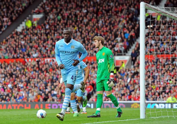 Mario Balotelli (L) celebrates scoring his second goal as David De Gea looks on Credit: Getty/AFP