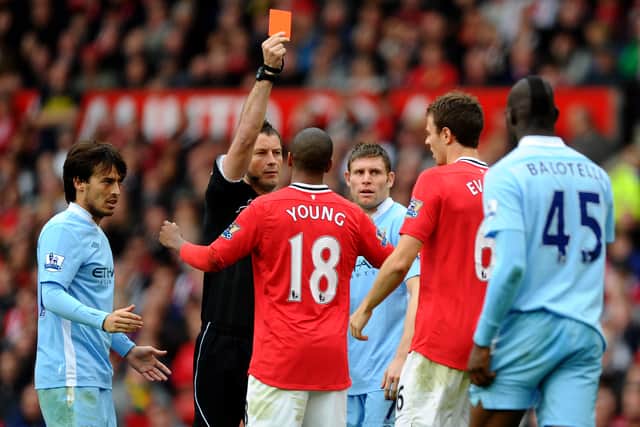 Referee  Mark Clattenburg shows a red card to Jonny Evans  Credit: Getty Images