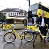 Greater Manchester Mayor Andy Burnham with a Bee Network bike and bus. Photo: TfGM