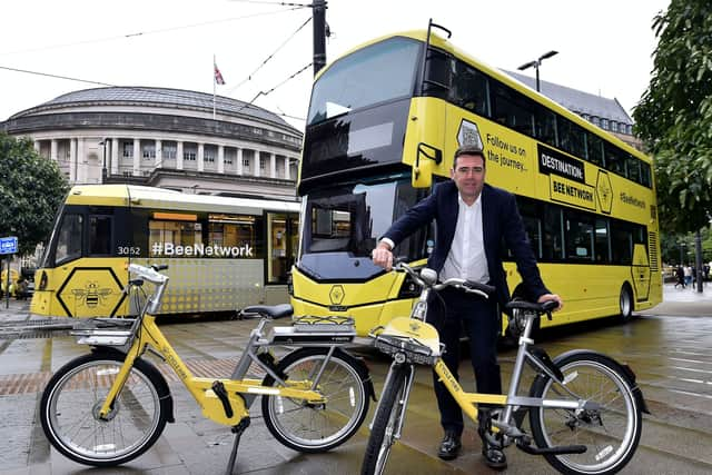 Greater Manchester Mayor Andy Burnham with a Bee Network bike and bus. Photo: TfGM