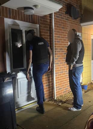 Officers attending one of five addresses in the Birmingham area where warrants were executed Credit: GMP