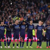 Man City players watch as the winning penalty is scored  Creit: Getty