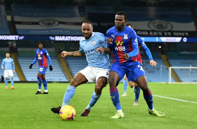 <p>Raheem Sterling is closed down by Tyrick Mitchell. Credit: Getty.</p>