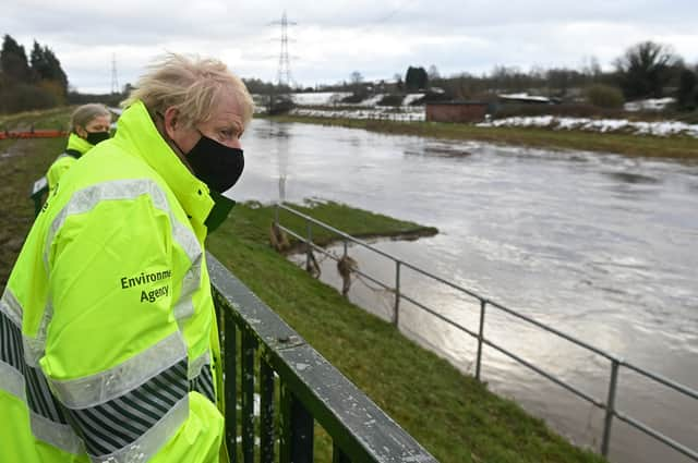 Boris Johnson visits Manchester during wet weather