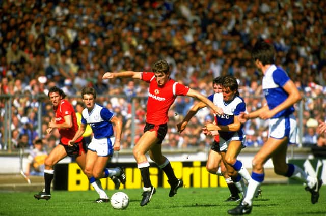 <p>Norman Whiteside playing against Everton in 1985. Credit: Getty.</p>