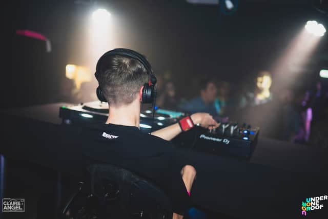 A DJ spins the decks at Under One Roof