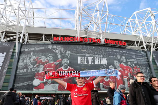 A young fan outside Old Trafford ahead of the fixture with City  Credit: Getty Images