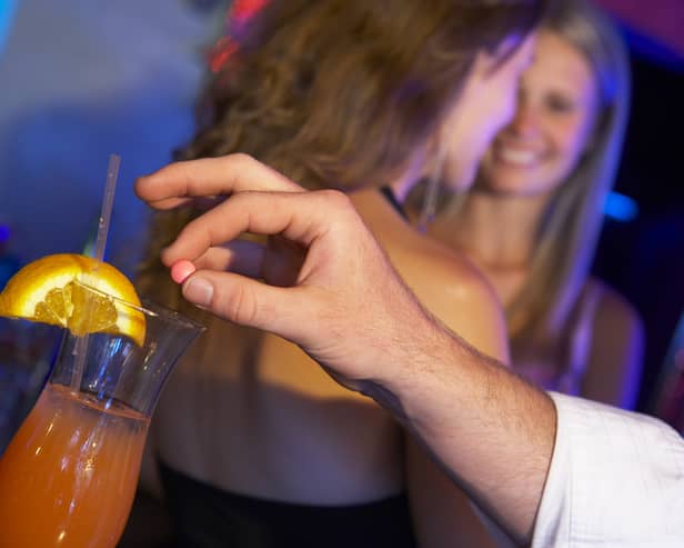 A drink being spiked  Credit: Shutterstock (posed by models)