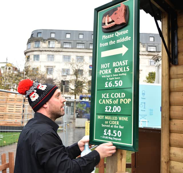 Photo: David Hurst Manchester Christmas Markets: a stall holders prepares to open