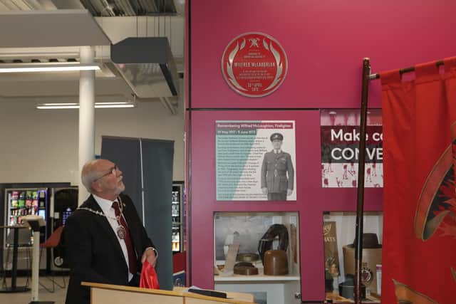 The red plaque is unveiled for Wilfred