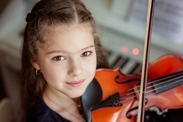 Child with a violin Credit: Shutterstock