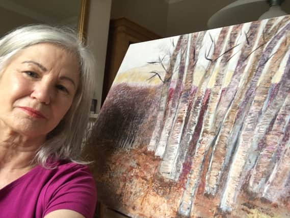 Julie Colville with one of her paintings