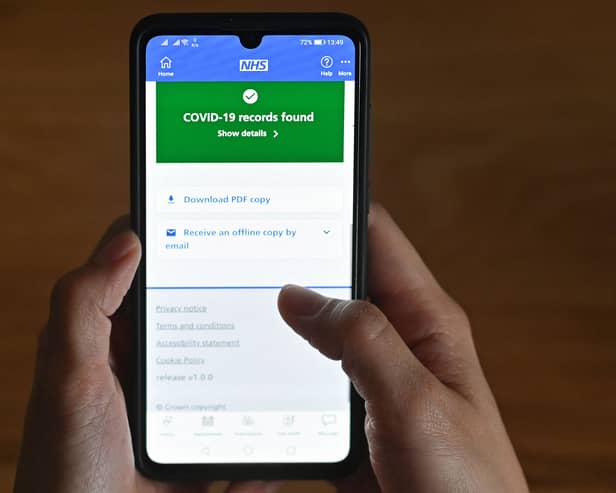 An illustration picture shows a smartphone screen displaying a Covid-19 vaccine record on the National Health Service (NHS) app.
