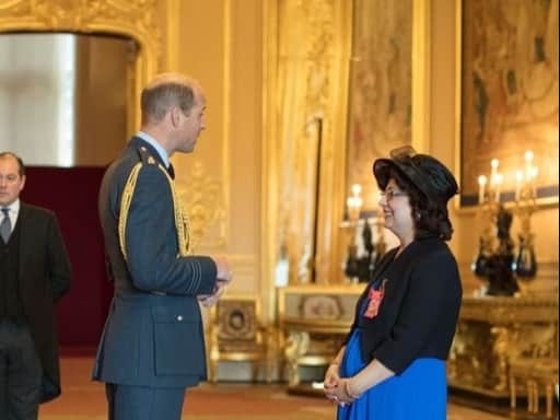 Qaisra Shahraz receiving her MBE from Prince William