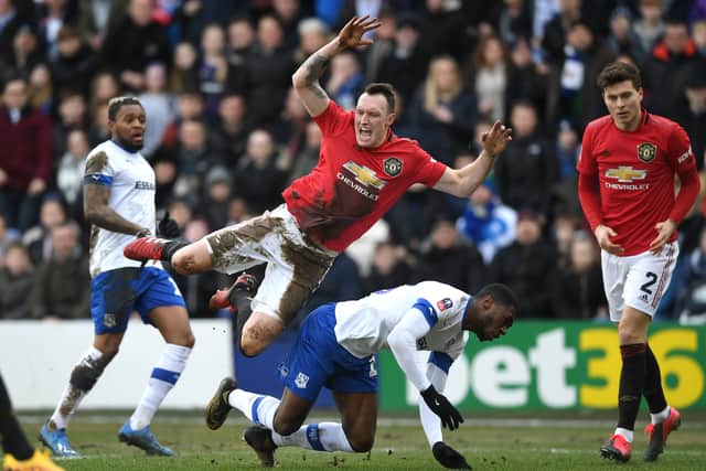  Phil Jones of Manchester United is tackled by Corey Blackett-Taylor of Tranmere Rovers   Credit: Getty