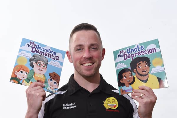 Alex Winstanley with two of his children’s picture books