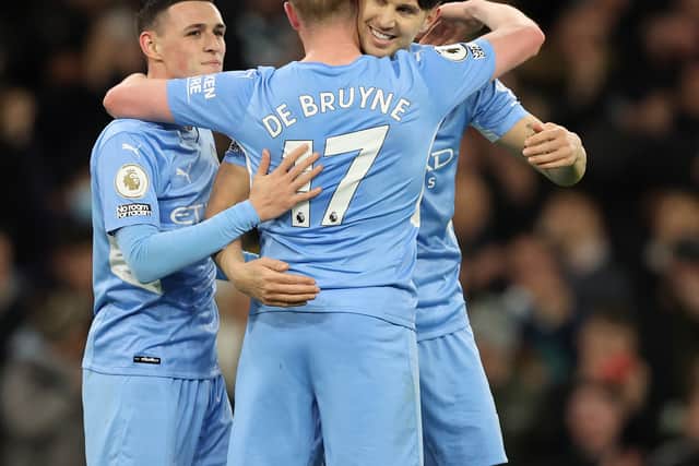Kevin De Bruyne of Manchester City celebrates after scoring their side's fifth goal with Phil Foden and John Stones during the Premier League match between Manchester City and Leeds United at Etihad Stadium 