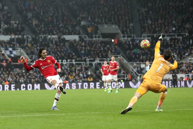 Edinson Cavani of Manchester United chips the ball over Martin Dubravka of Newcastle United during the Premier League match between Newcastle United  and  Manchester United at St James' Park on December 27, 2021