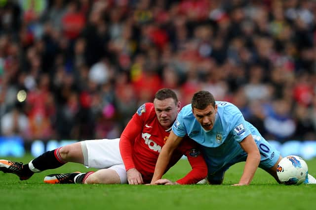   Edin Dzeko  with Wayne Rooney Credit: Getty