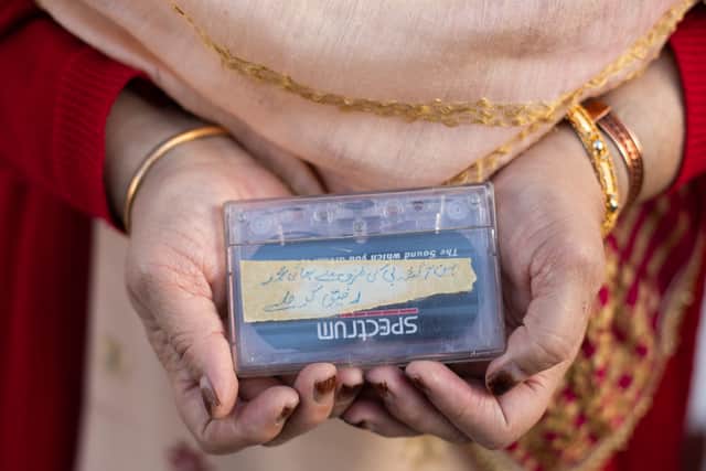 Aziza Din holding one of the Tape Letters cassettes. Photo: Maryam Wahid