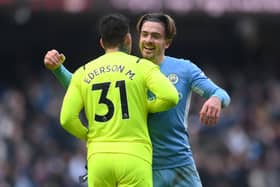  Jack Grealish embraces Ederson as Man City go 11 points clear Credit: Getty