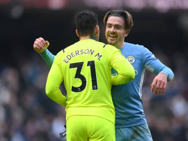  Jack Grealish embraces Ederson as Man City go 11 points clear Credit: Getty